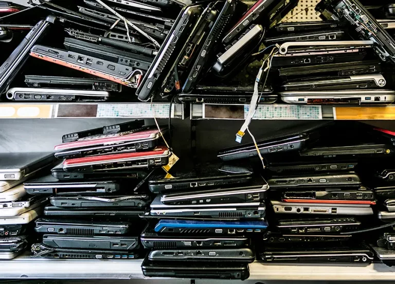 Stacks of old laptops ready for proper electronics recycling by Great Chesapeake IT Recycling and Data Destruction